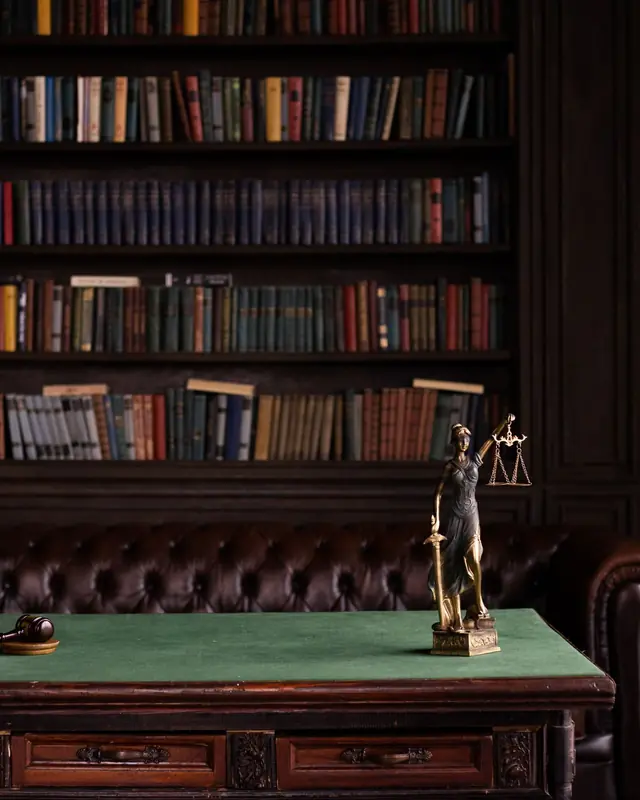 Law library with bookshelves, a desk and a Lady Justice figurine