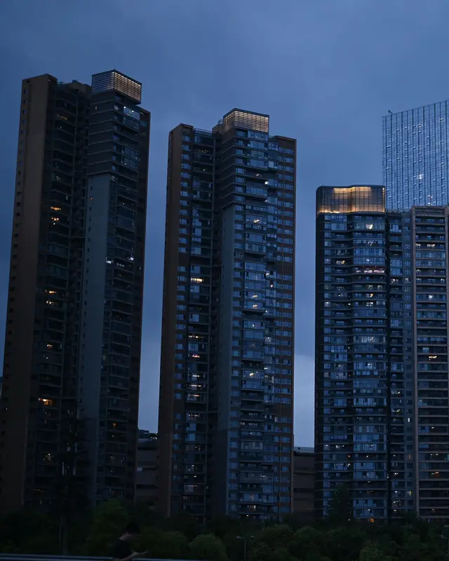Residential towers at dusk with lit windows