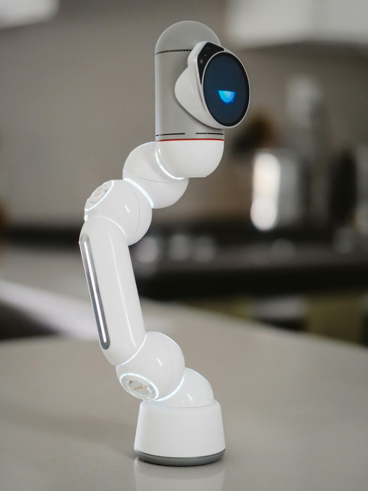 Close-up of a modern humanoid robot arm indoors, illustrating innovation.